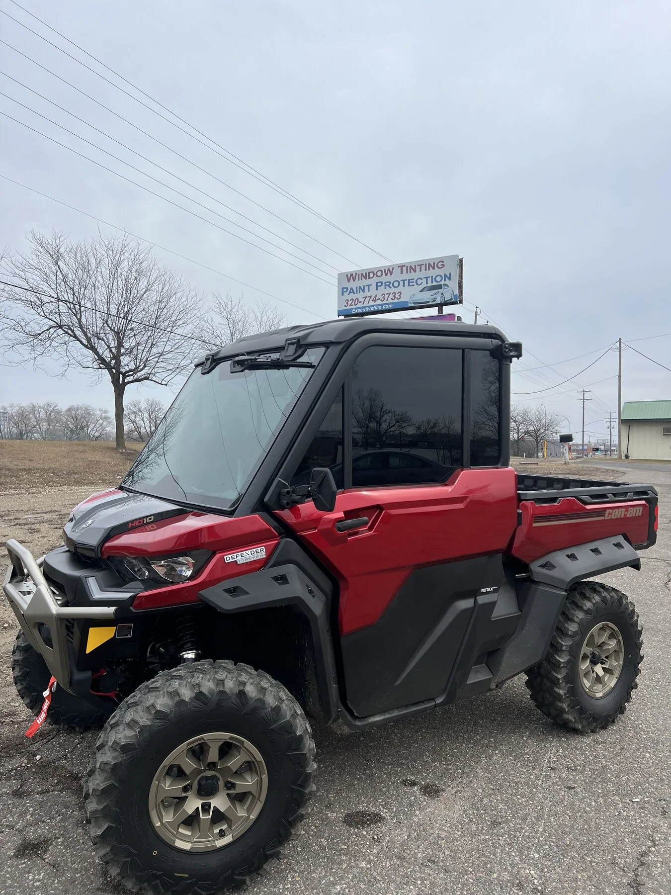 Red enclosed-cab side-by-side outdoors