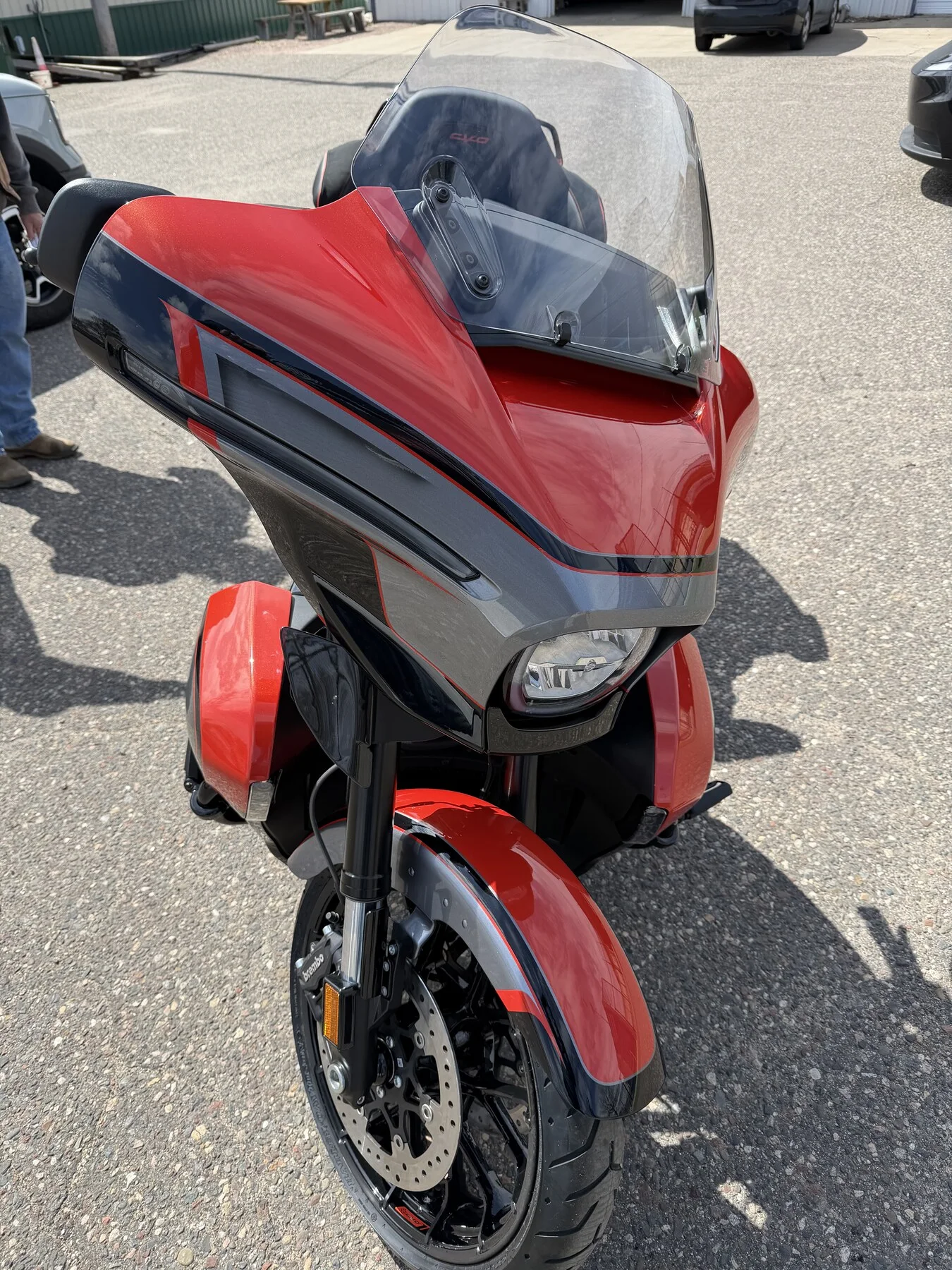 Red touring motorcycle outside the shop