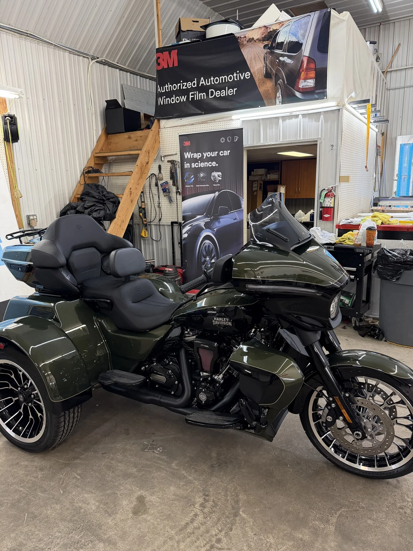 Green touring motorcycle inside the workshop