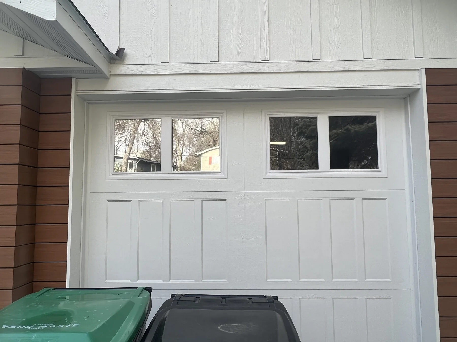 Residential garage door with a row of windows