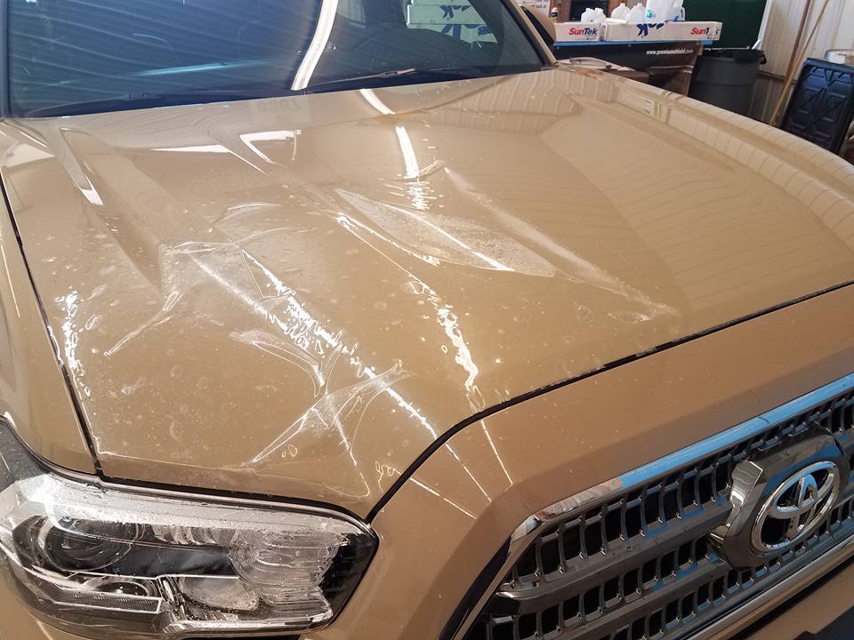 Vehicle paint being machine polished during paint correction at Executive Film in Waite Park, MN